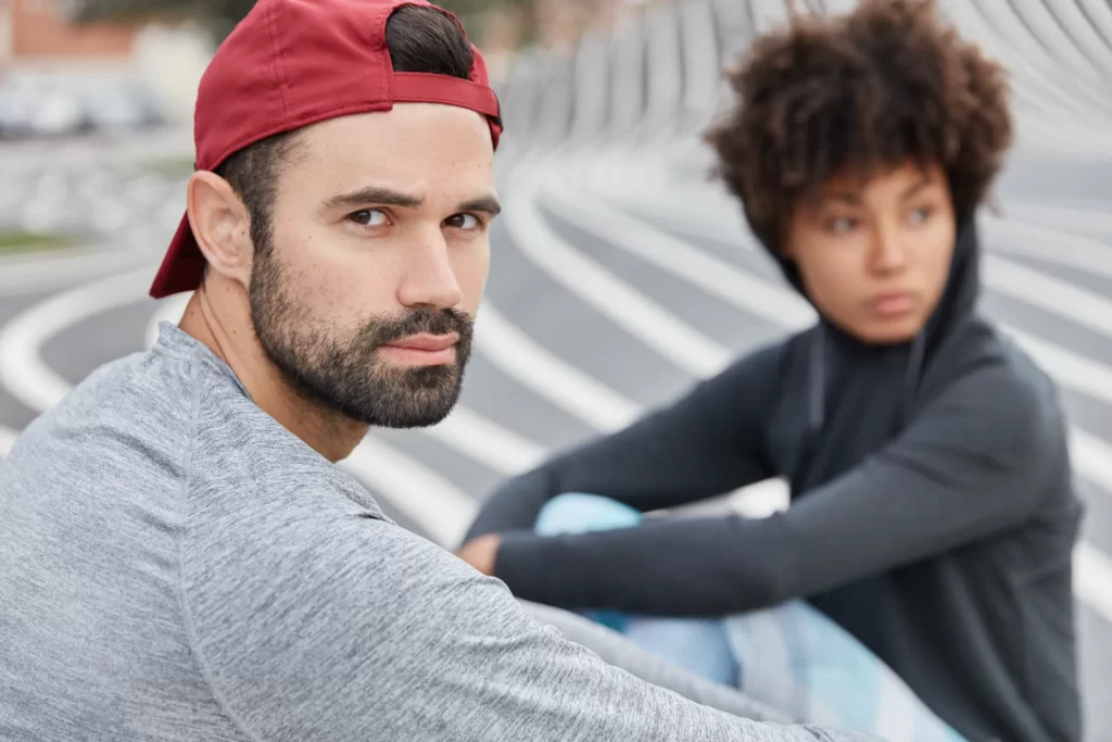 contemplative man with friend outdoors on striped utc