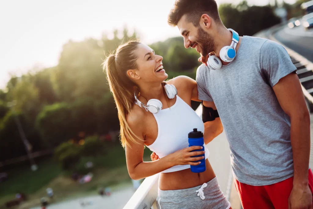 smiling couple taking a break after workout outdoo utc